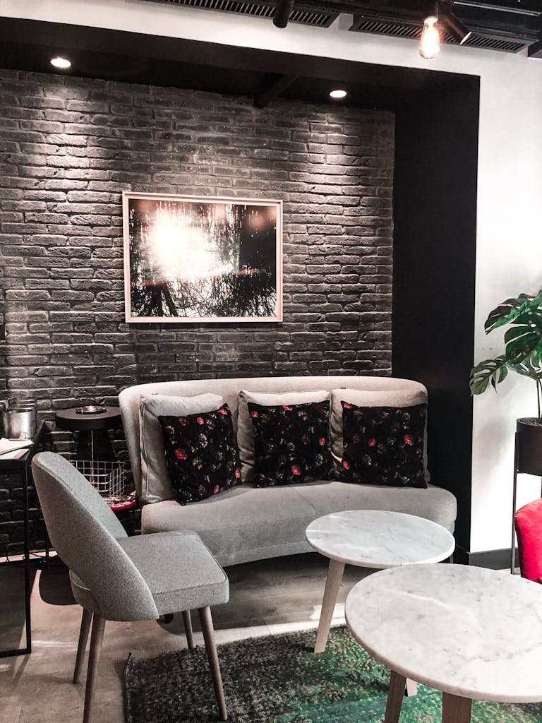 Chic modern lounge with elegant furniture, cozy lighting, and stylish brick wall decor.